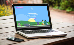 Responsive website design showcasing house removal services on laptop in outdoor Welsh setting