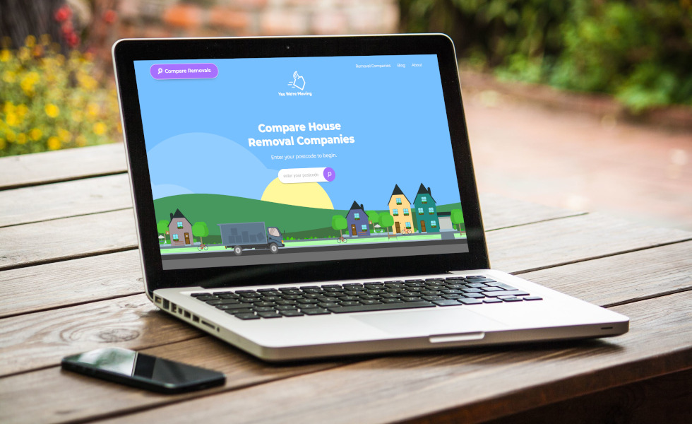 Responsive website design showcasing house removal services on laptop in outdoor Welsh setting